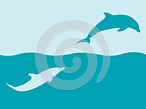 Two silhouettes of dolphins playing in water