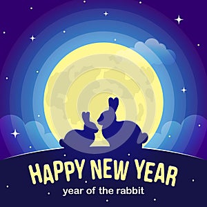 Two silhouettes of a rabbit against the background of a yellow moon and a blue sky with stars