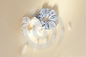 two silk scrunchies on light white. Flat lay Hairdressing tools and accessories. Elastic Hair Bands, Bobble Sports from