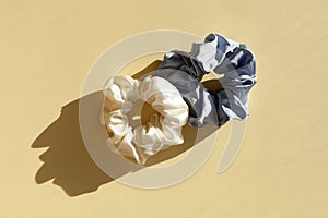 two silk Scrunchies on sunlight with shadows. flat lay of Hairdressing tools and accessories. Hair Scrunchies, Elastic