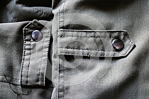 Two Silver Buttons on a Pastel Green Jacket.