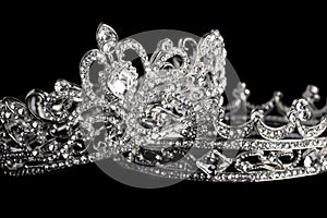 Two Silver Crowns Isolated on a Black Background photo