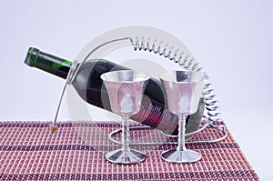 Two silver cups and a bottle of wine