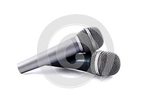 Two silver microphones isolated over white