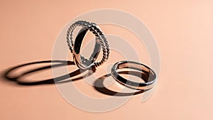 Two Silver Rings on Beige Background