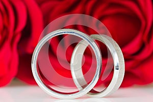 Two silver rings with red roses