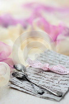 Two silver teaspoons on a letter