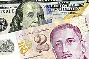 A two Singapore dollar bill with a new American one hundred dollar bill