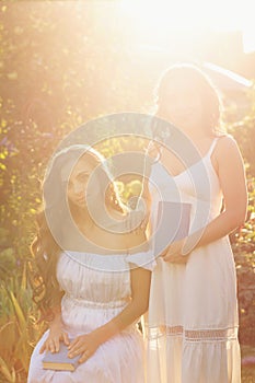 Two sisters and books. Sunset