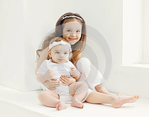 Two sisters children playing together at home