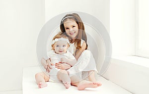 Two sisters children playing together at home