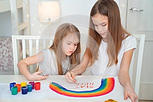 Two sisters write stay at home. flashmob. rainbow.