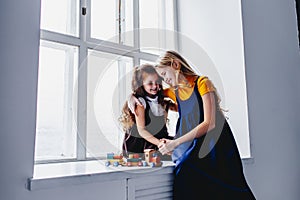 Two sisters having fun. Playing with toy train. Togertherness and friendship