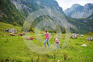 Two sisters on a hiking trails around picturesque Konigssee, known as Germany`s deepest and cleanest lake, located in the extreme