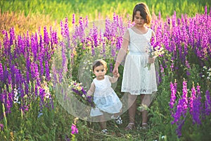 Two sisters holding hands in the flower chain