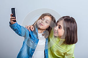 Two sisters posing and taking selfies in the studio