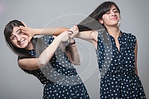 Two sisters pulling hair