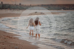 Two sisters  on the shore of the sea