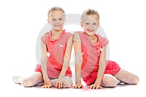 Two sisters sit on the floor