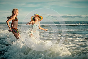 Two sisters splashing on the beach