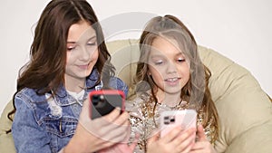 Two sisters take selfies at home, smiling friends taking a self shot with phone