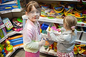 Two sisters in toy store