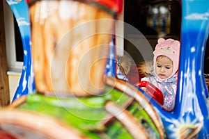 Two sisters in train carousel in amusement park