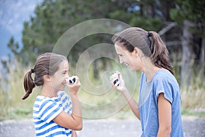 Two sisters very close talking with a walkie-talkie