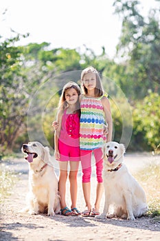 Two sisters on a walk with the dogs in the park