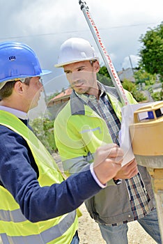 Two site surveyors on job