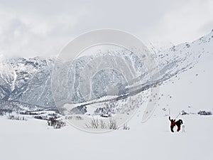 Two skiers in a mountain landscape in bad weather in winter