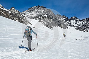 Two skiers skinning up slope near Snowbird Mine in Hatcher Pass area in the Talkeetna Mountains, Alaska