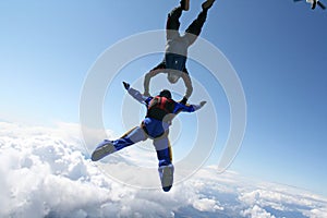 Two skydivers exit an airplane