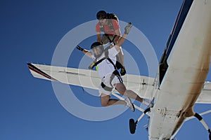 Two skydivers exit an airplane photo