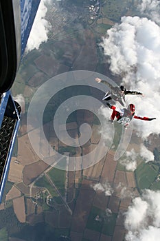 Two skydivers exit a plane photo