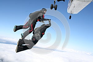 Two skydivers jump from a plane