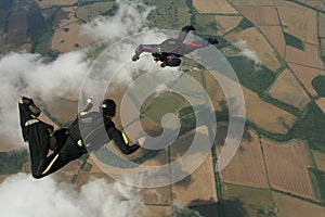 Two skydivers performaing formations