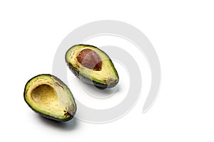 Two slices of avocado isolated on the white background. One slice with core