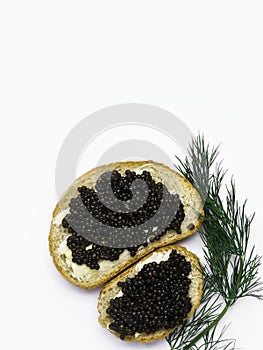 Two slices of baguette with butter and black caviar isolated on white background. Luxurious delicacy appetizer