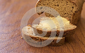 Two slices of banana bread on a wooden board