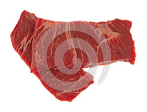 Two slices of beef chuck boneless short rib steak on a white background top view
