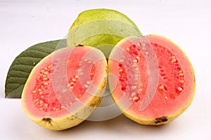 Two slices of Pink Guava fruit with leaf. photo