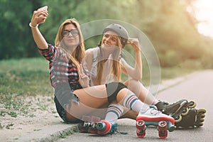 Two slim and young women and roller skates. One female has an inline skates and the other has a quad skates. Girls