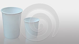 Two small and big size white empty cups are kept isolated
