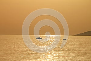 Two small boats at beautiful sunset , Croatia