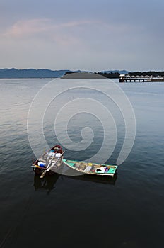 Two Small Boats and Public Pier in Calm Sea