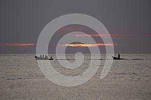 Two small boats at sunset