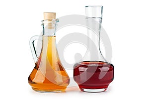 Two small decanters with apple and red wine vinegar photo
