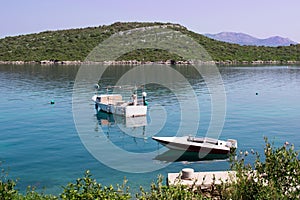 Two small fishing boats in calm waters of Mediterranean Adriatic sea in Croatia