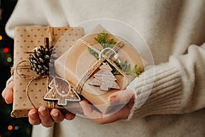 Two small gift boxes in female hands. Close up